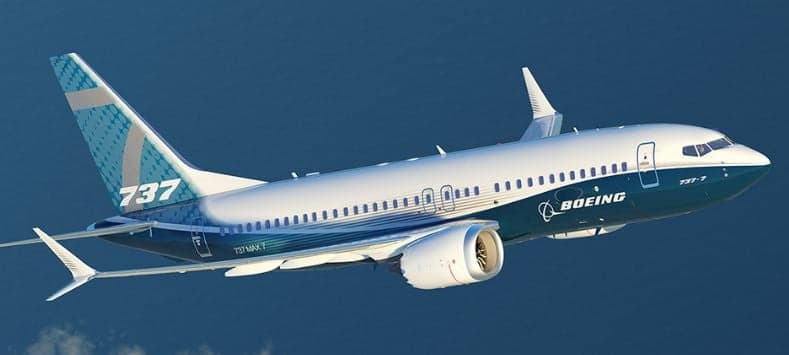 A Boeing 737 MAX 7 in flight against a blue sky.