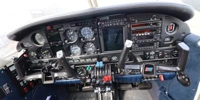 Close-up view of an aircraft cockpit with various instruments and controls.