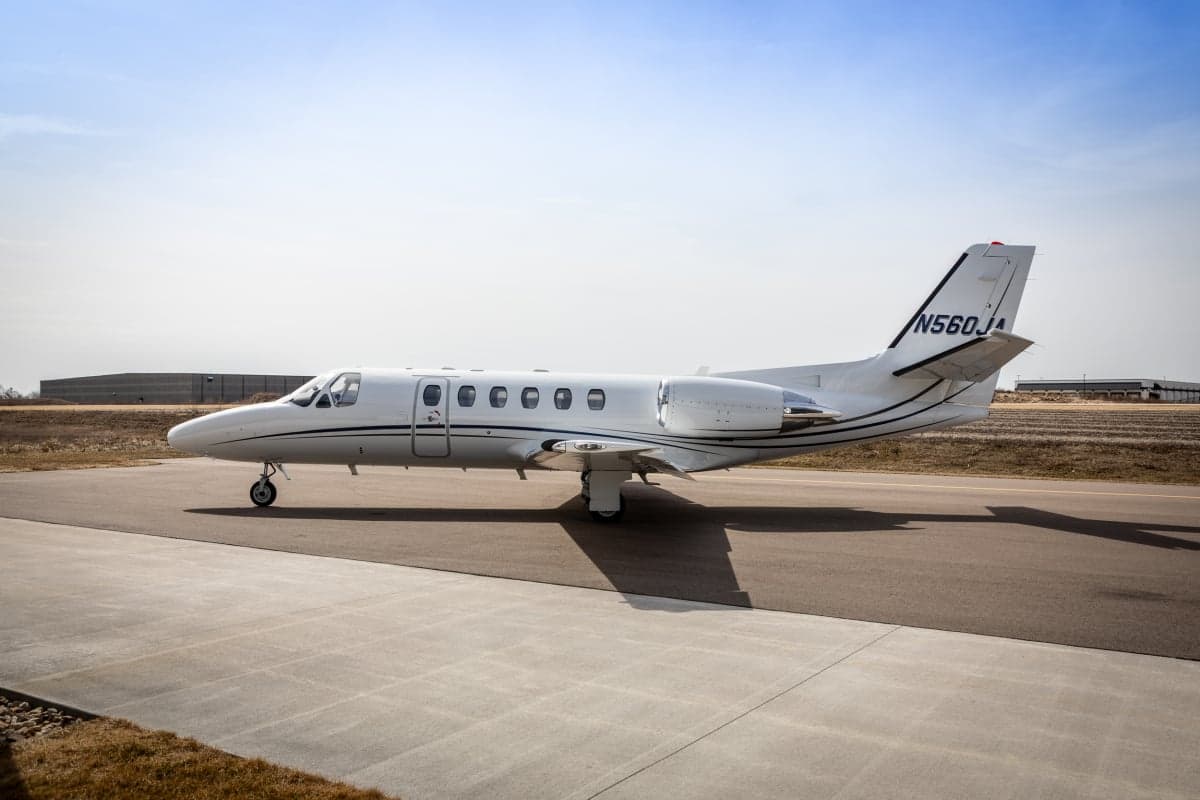 A Citation CJ3 aircraft with registration N560JA is parked on the tarmac.