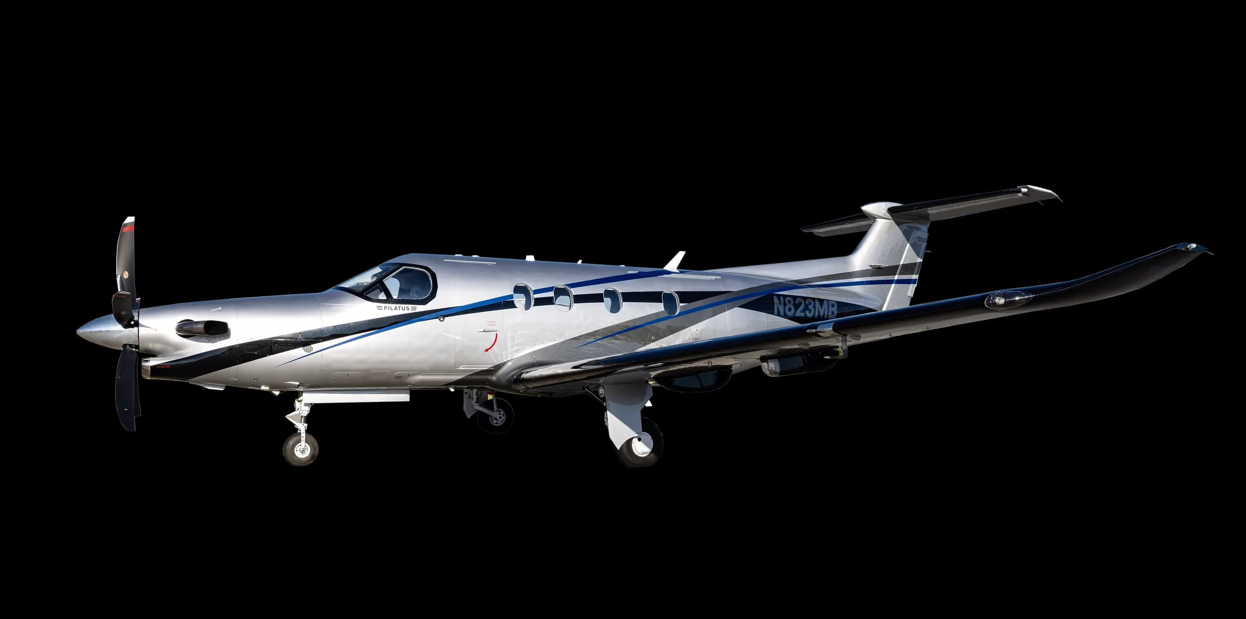 A silver Pilatus PC-12 aircraft with blue and black stripes, seen from the side on the ground.