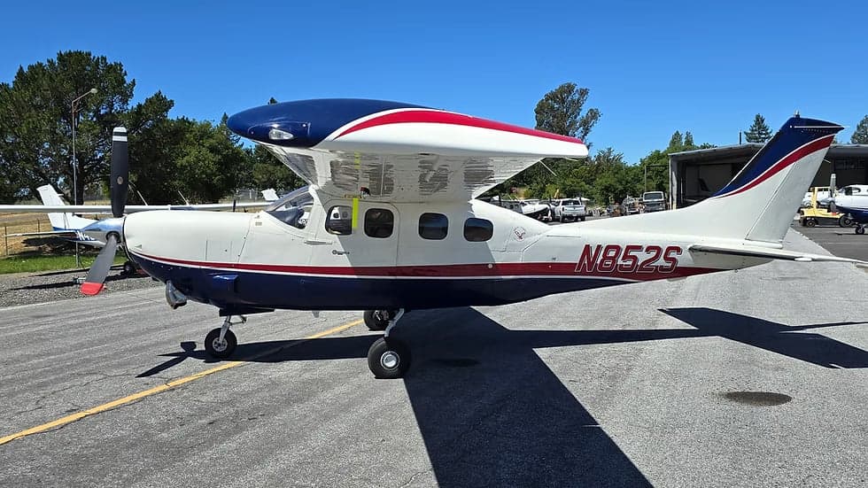 Side view of a Cessna 207A Turbo Stationair 800, registration N852S, parked on the tarmac.