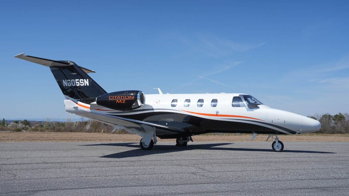 A Citation M2 aircraft with registration N605SN is parked on the tarmac.