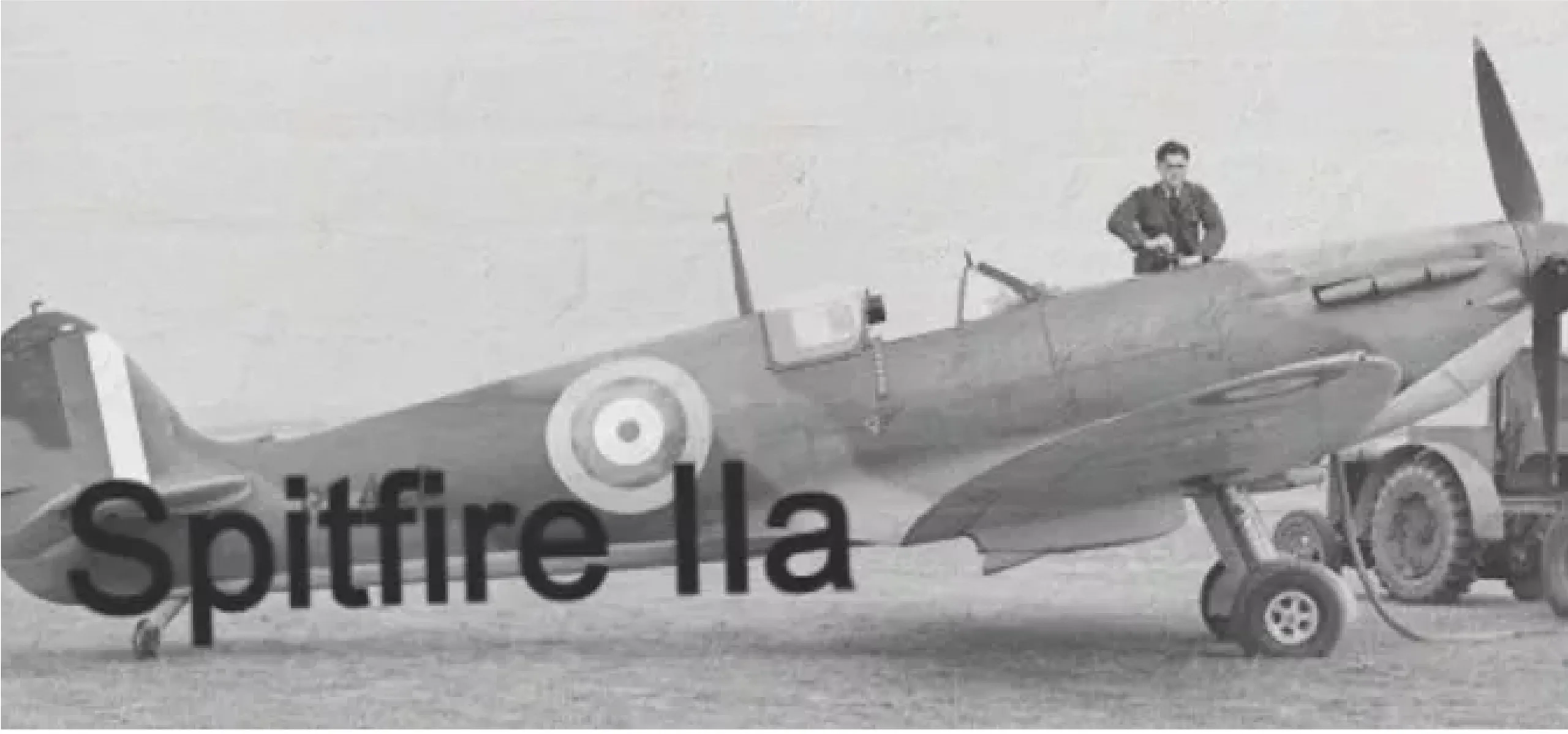 A Spitfire IIa aircraft with a pilot standing on the wing.