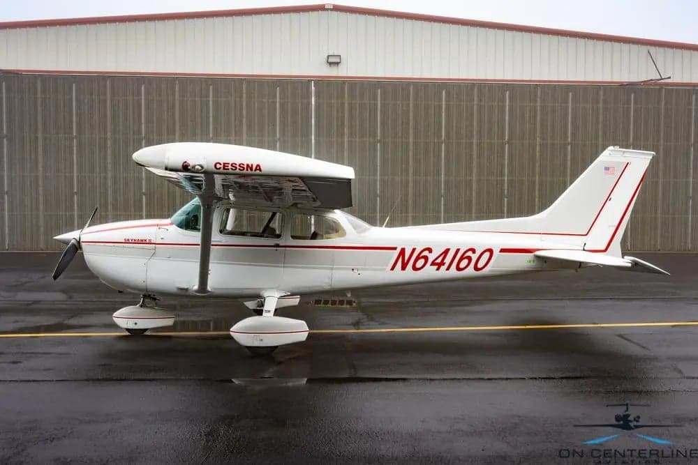 Cessna 172 Skyhawk, registration N64160, parked on the tarmac.