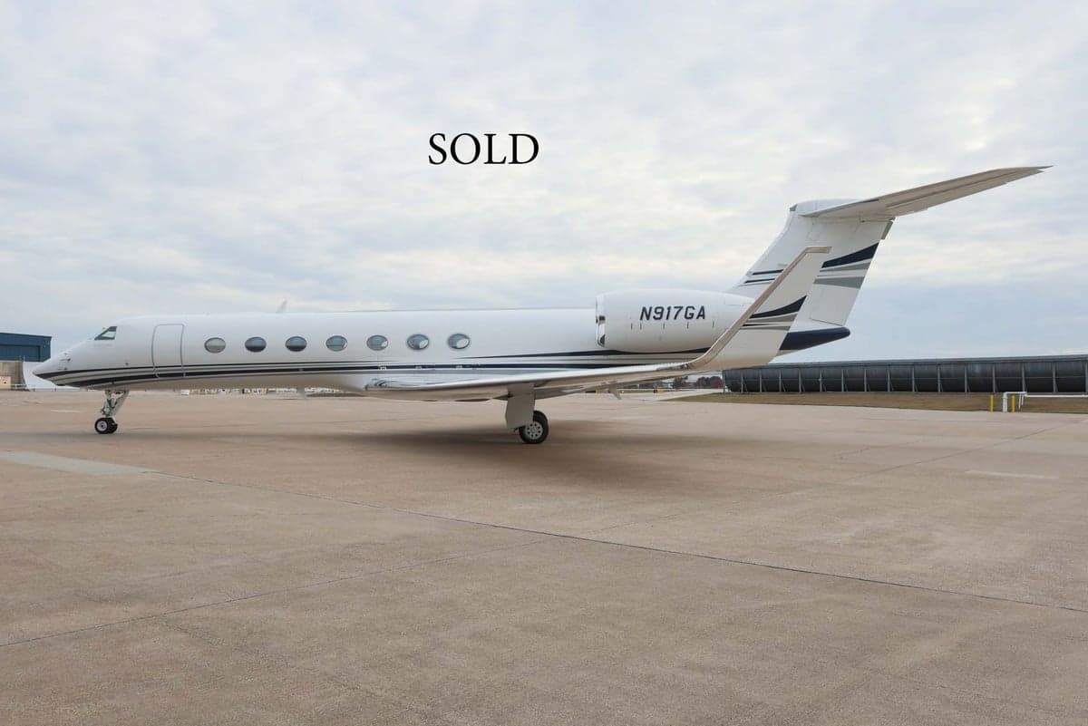 Gulfstream G550 aircraft N917GA parked on the tarmac with SOLD text overlayed.