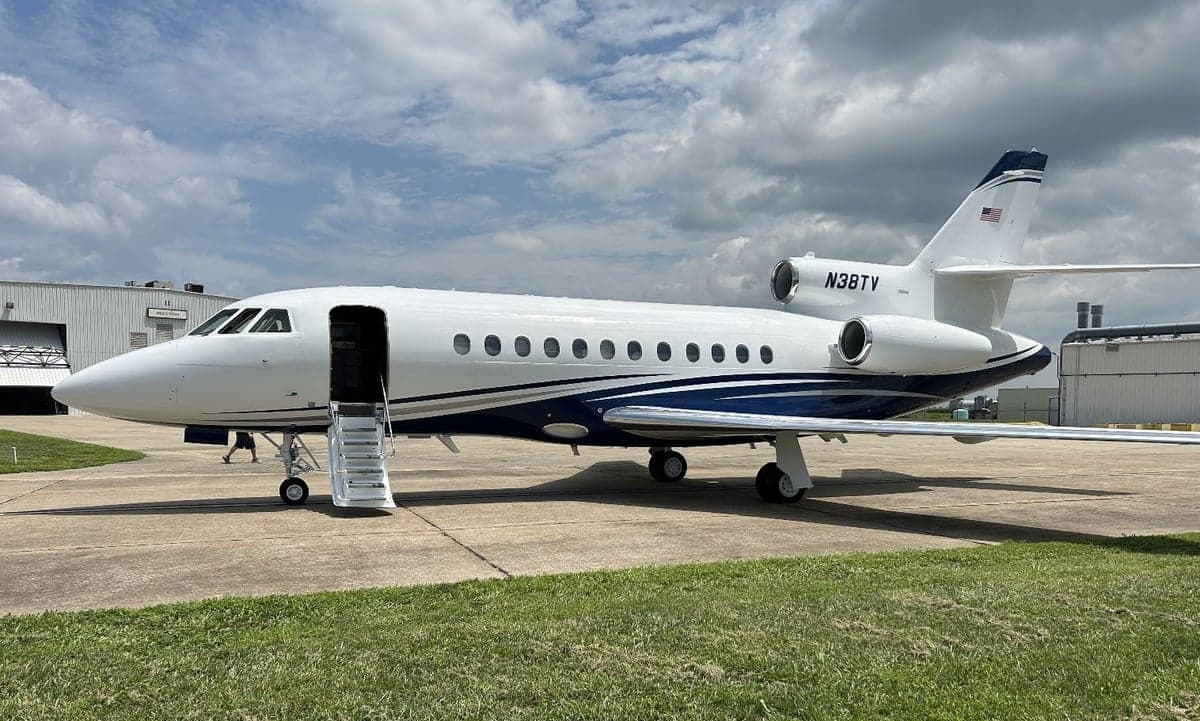 Falcon 50 aircraft N38TV parked on the tarmac.