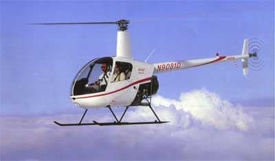 White Robinson R22 helicopter in flight with registration N9081D.