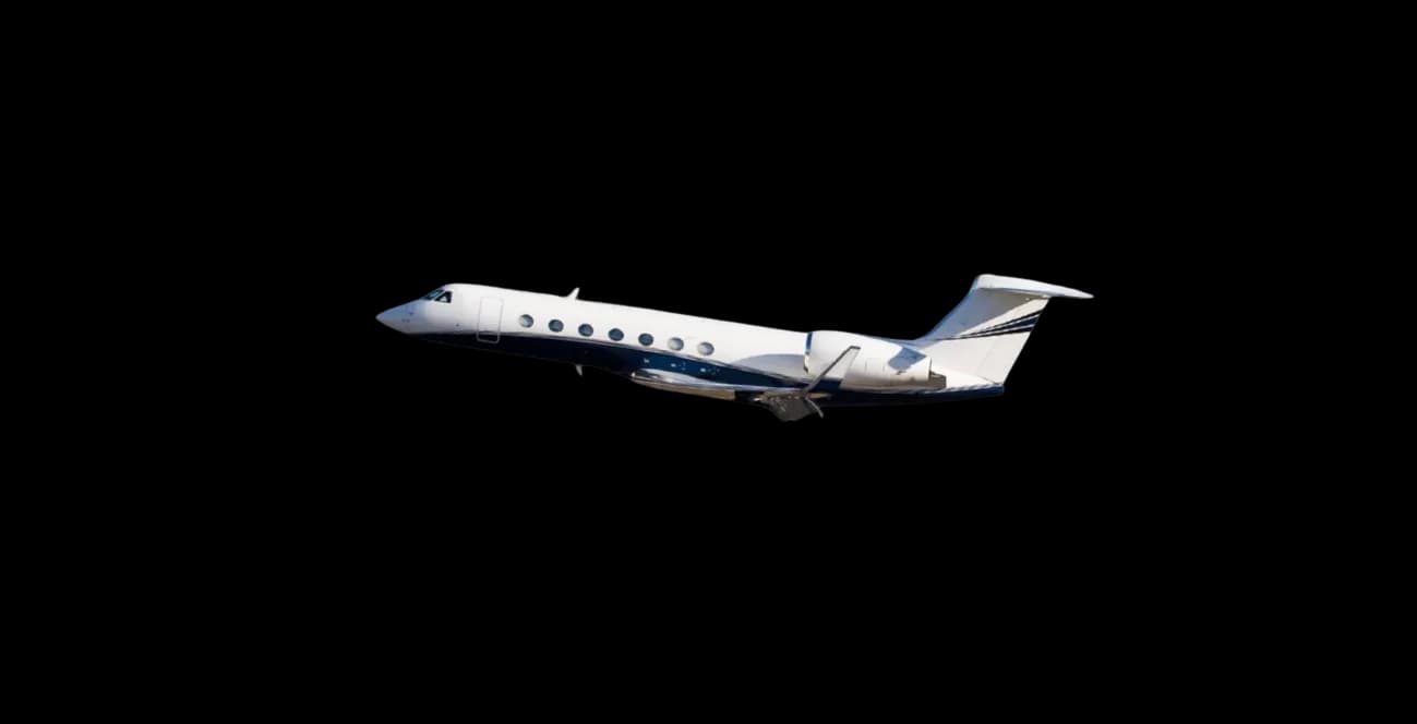 A white and blue private jet, possibly a Gulfstream, in flight against a dark background.