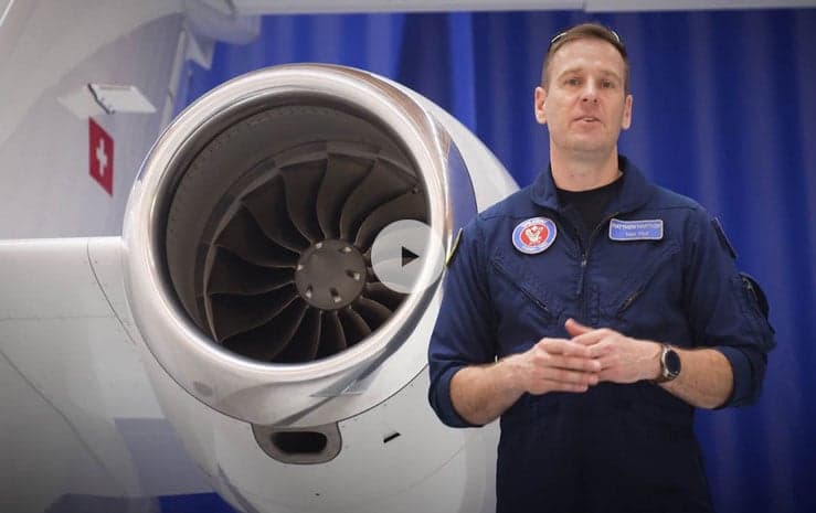 A man standing in front of a Pilatus PC-24 engine.