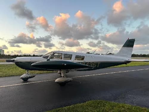 Piper PA-28-181 Archer II aircraft N1435T on the tarmac at sunset.