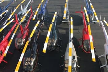 Overhead view of several Robinson helicopters parked on the tarmac.