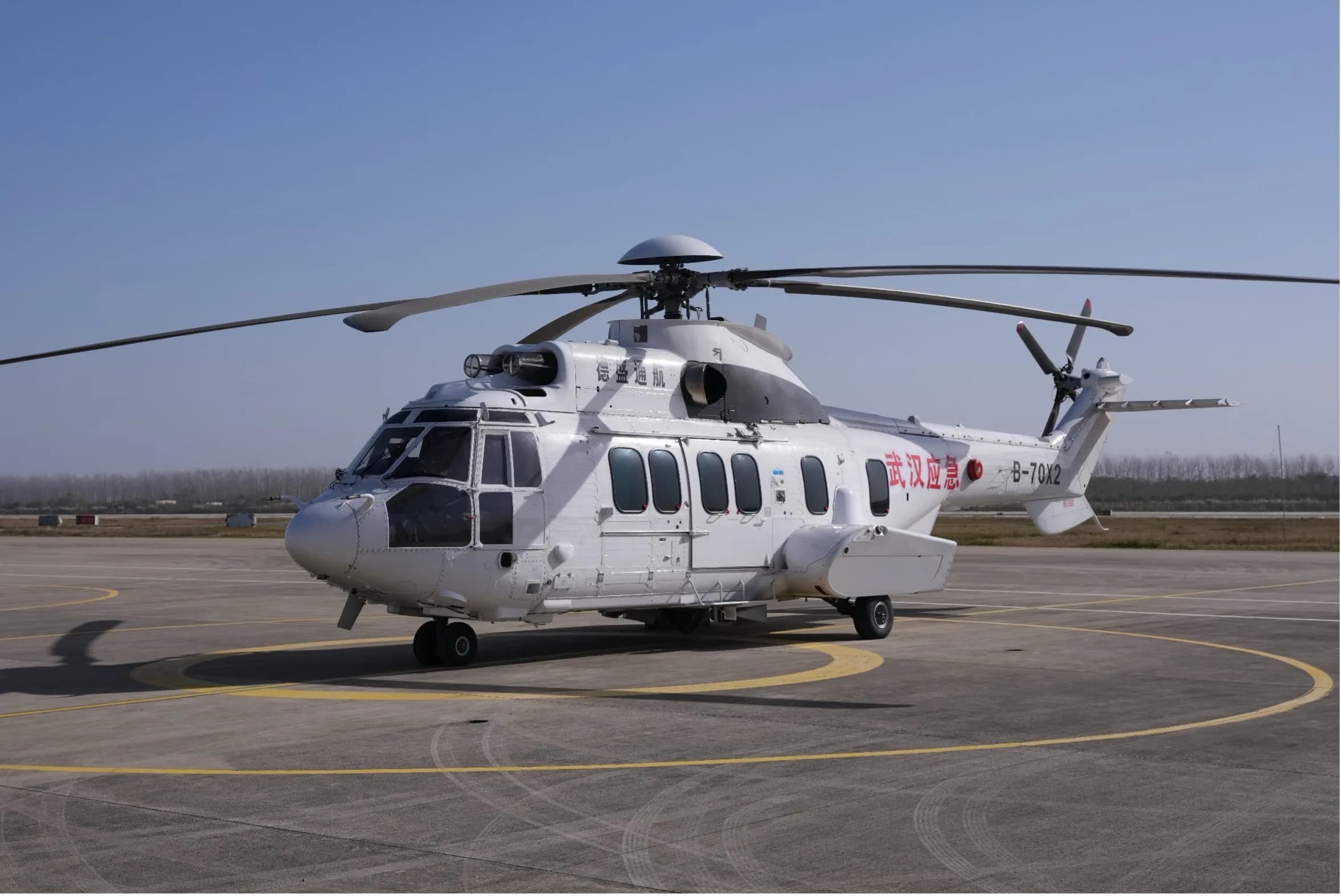 A front quarter view of a white Airbus Helicopters H225 Super Puma on the tarmac.