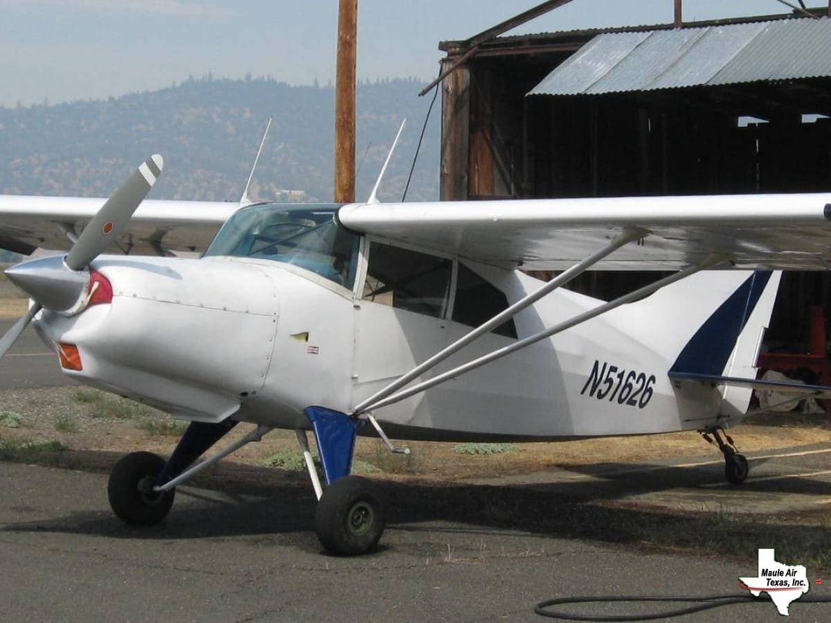 A white and blue Maule M-5-235C, registration N51626, parked near a hangar.
