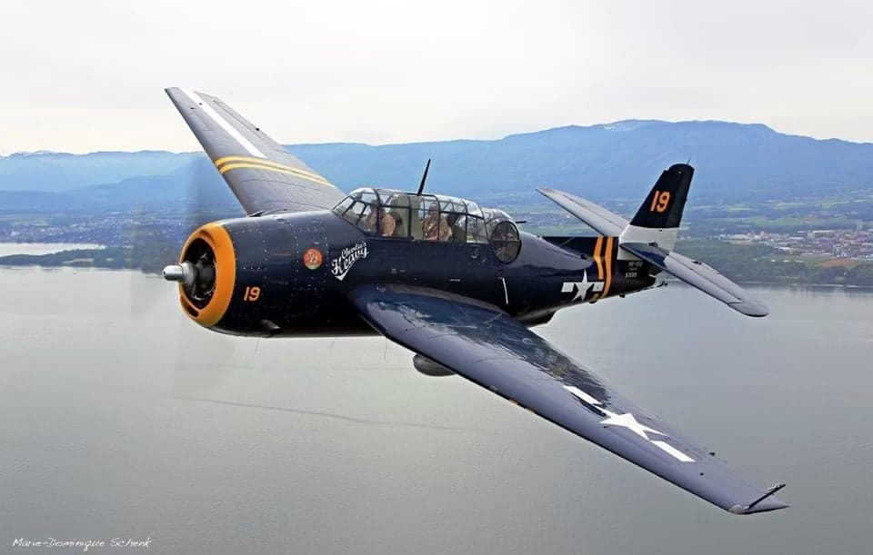 Grumman TBF Avenger in flight over water.