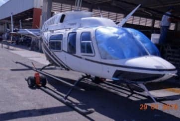 A Bell 206L-4 helicopter parked on the tarmac.