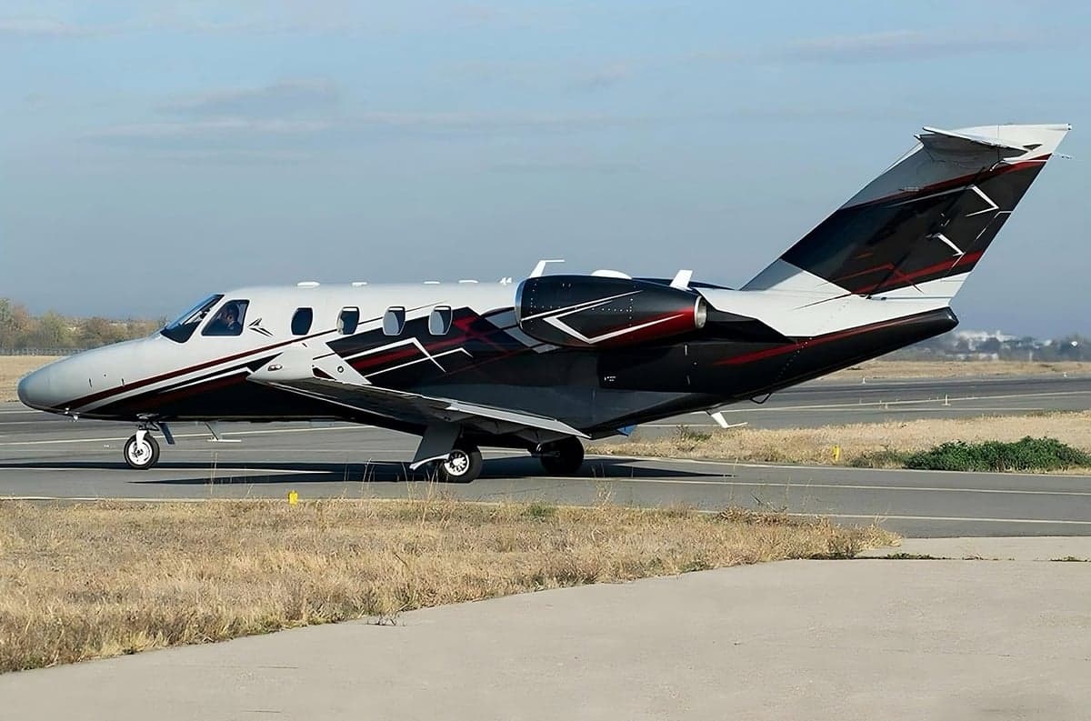 A Cessna Citation CJ4 on the tarmac with a custom paint scheme.