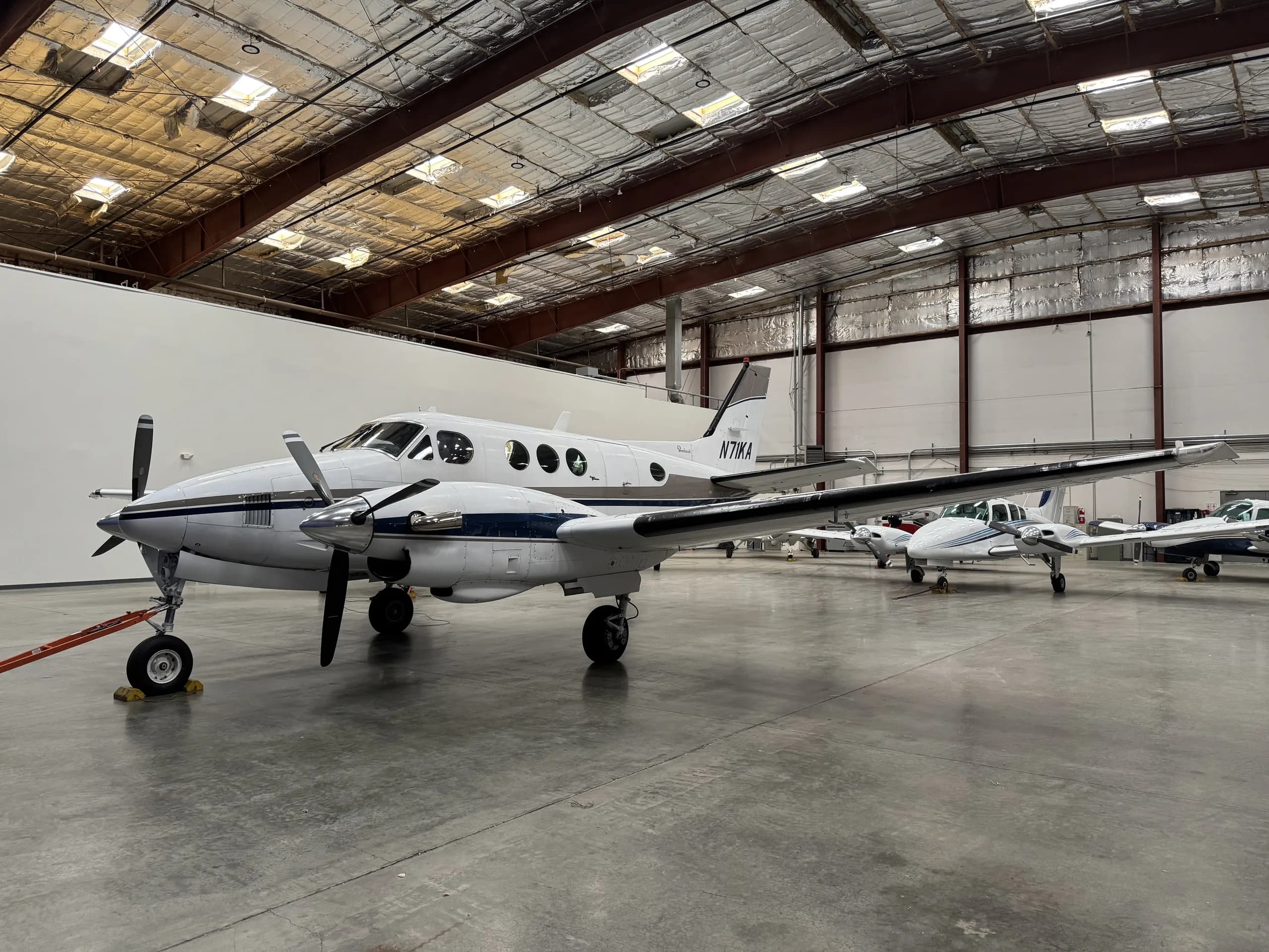 N71KA King Air turboprop aircraft parked in a hangar.