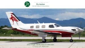 A Piper PA-46-500TP Meridian aircraft with a white and red paint scheme on the tarmac.