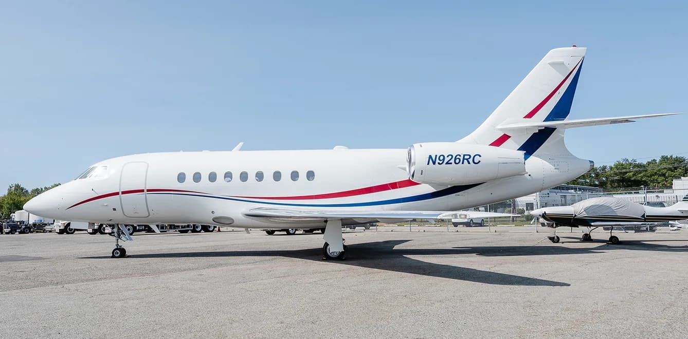 A Dassault Falcon aircraft with registration N926RC parked on the tarmac.