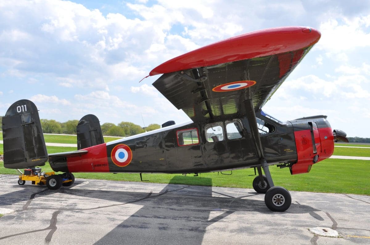 A Morane-Saulnier MS.505 Criquet aircraft is parked on the tarmac.