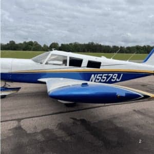 Side view of the N5579J aircraft on the tarmac.