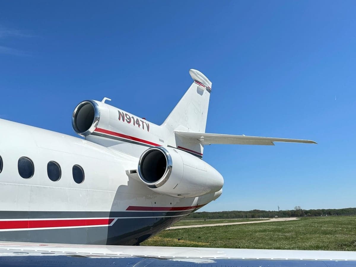 Close up of the tail section of the N914TV aircraft on the ground.