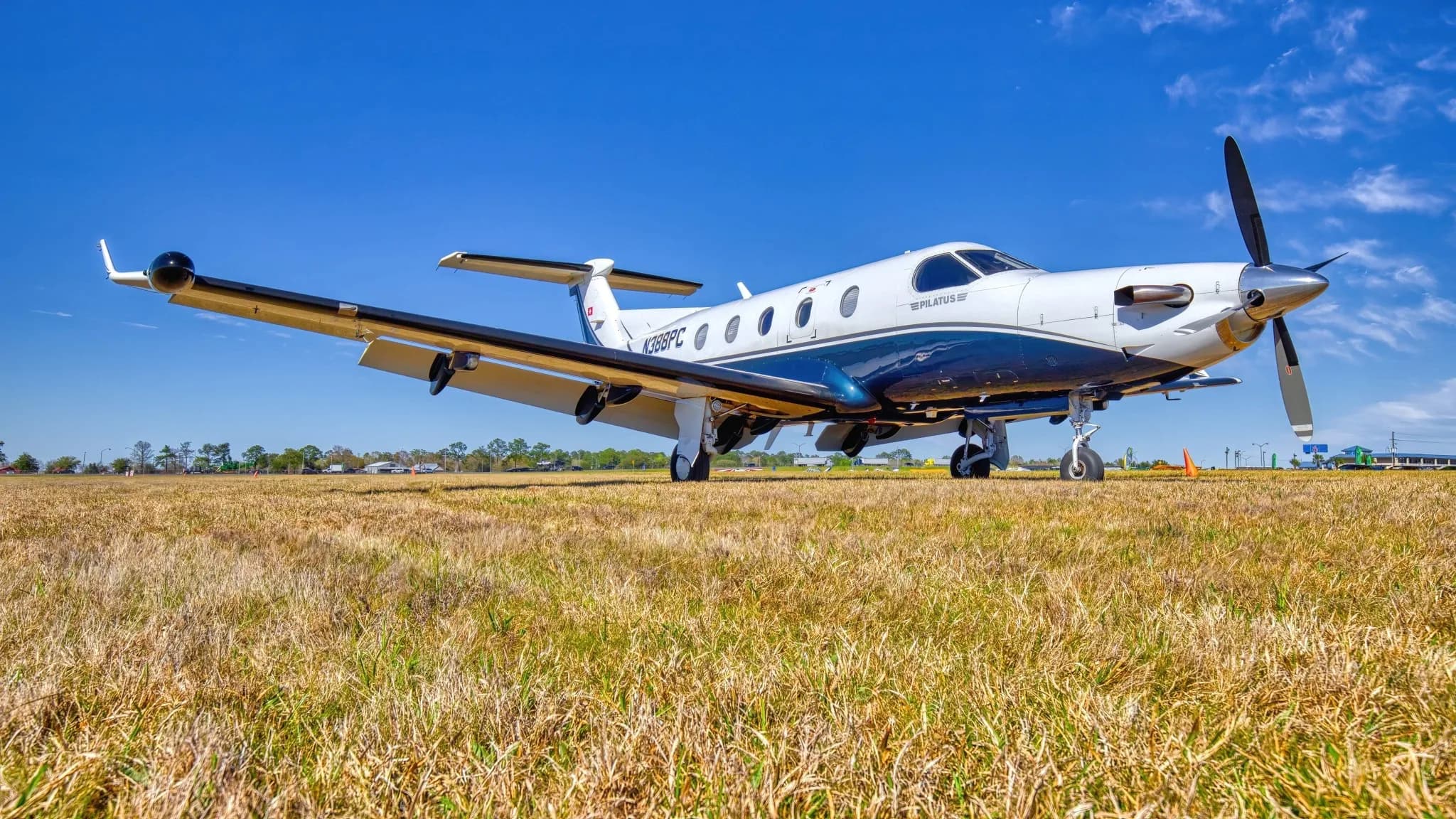Pilatus PC-12 NG on a grassy field.