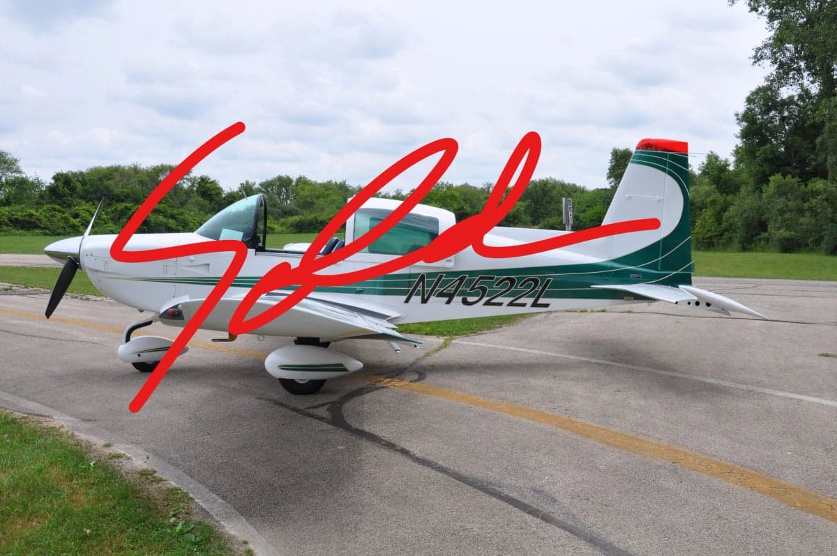 Side view of a white and green aircraft with the word SOLD overlaid.