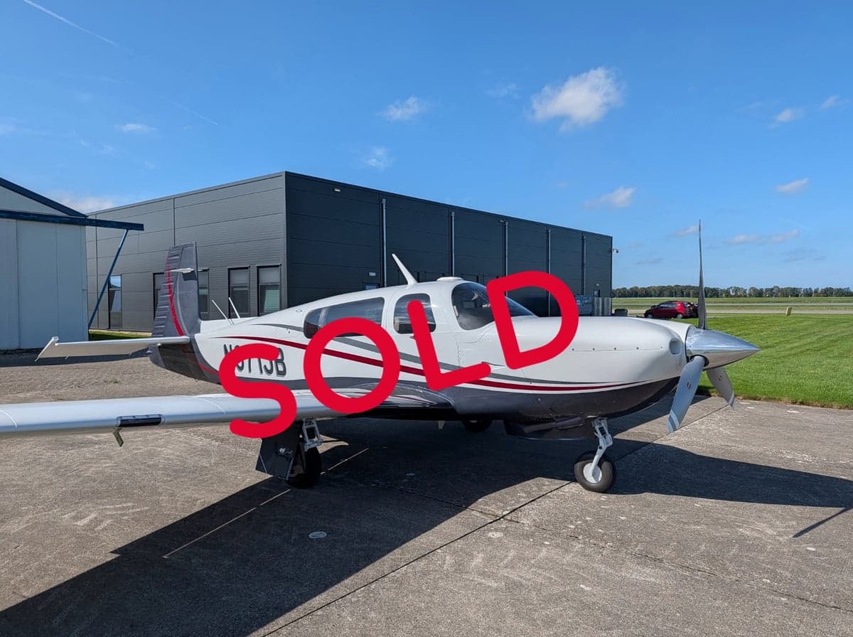 Mooney M20 aircraft N971JB on the ground with a SOLD overlay.
