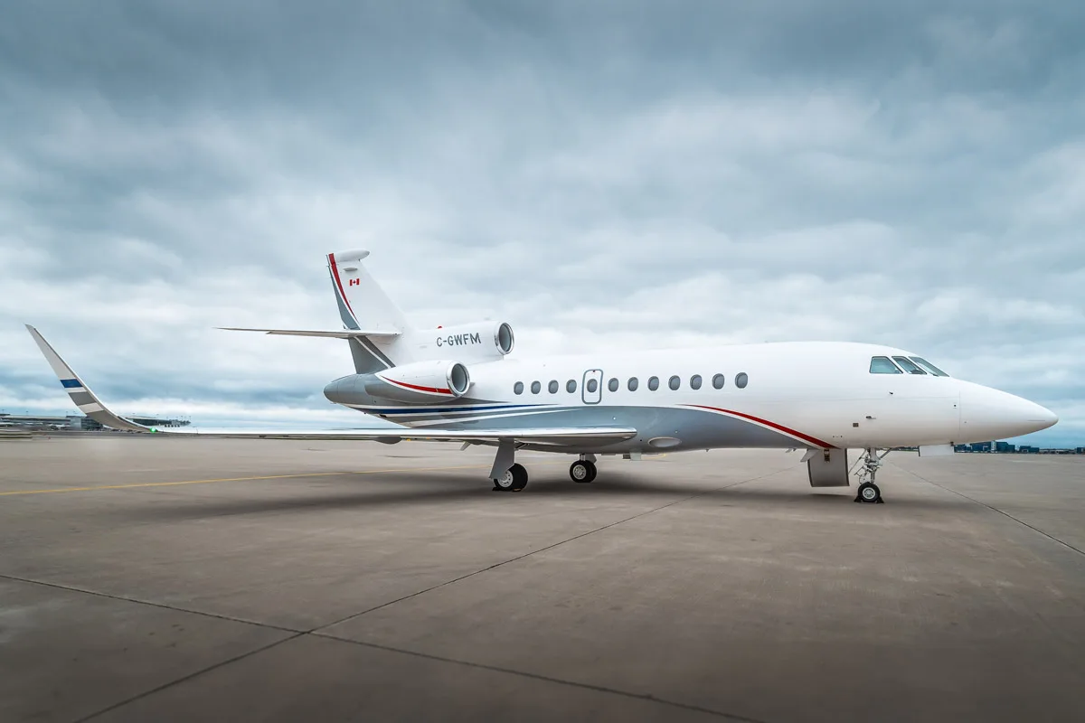 Side view of the C-GWFM aircraft on the tarmac.