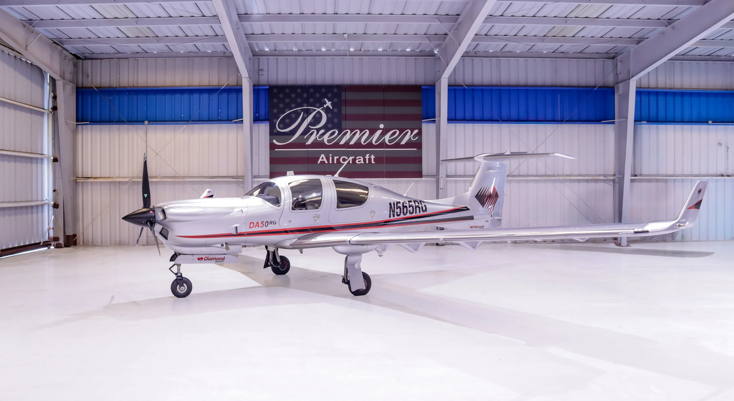 Diamond DA50RG aircraft N565RG parked in a hangar.