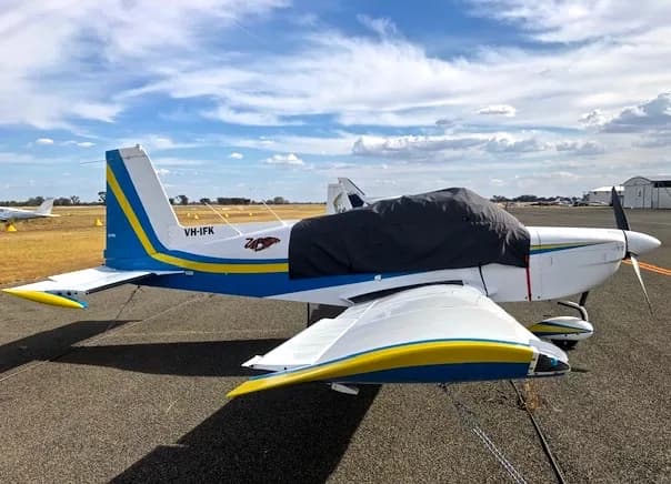 Side view of a white and blue single-engine aircraft with registration VH-IFK on the tail.