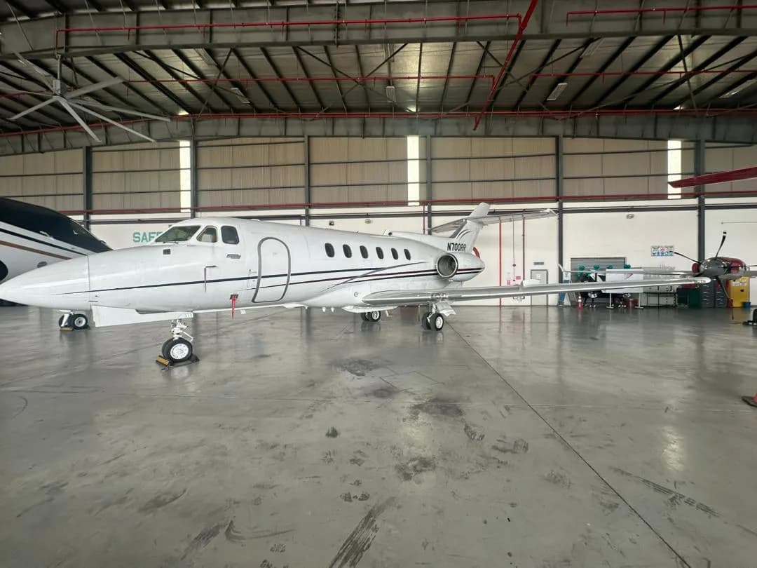 A Hawker 400XP aircraft with registration N700RR is parked inside a hangar.
