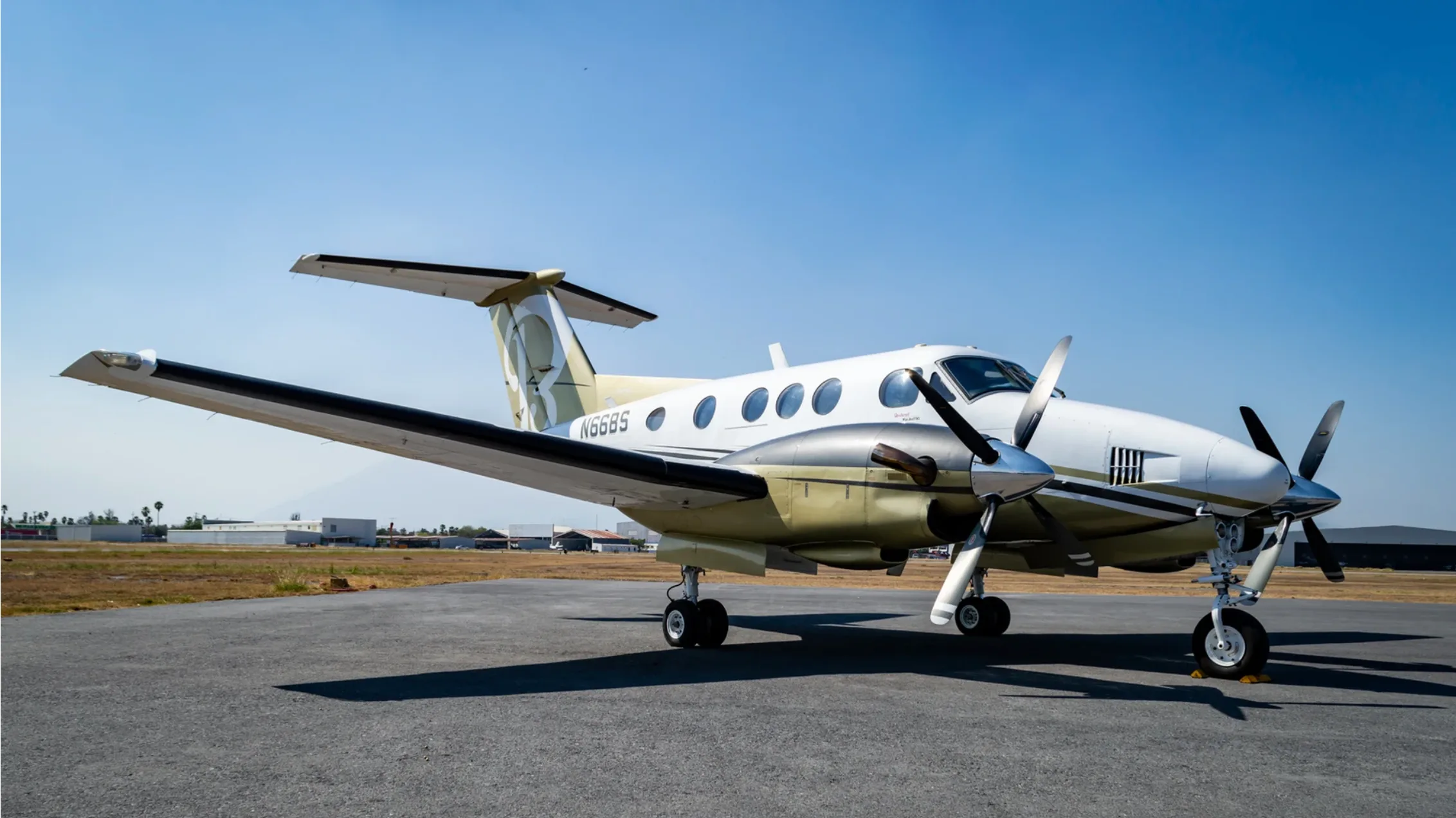 Beechcraft King Air 200, registration N66BS, parked on the tarmac.