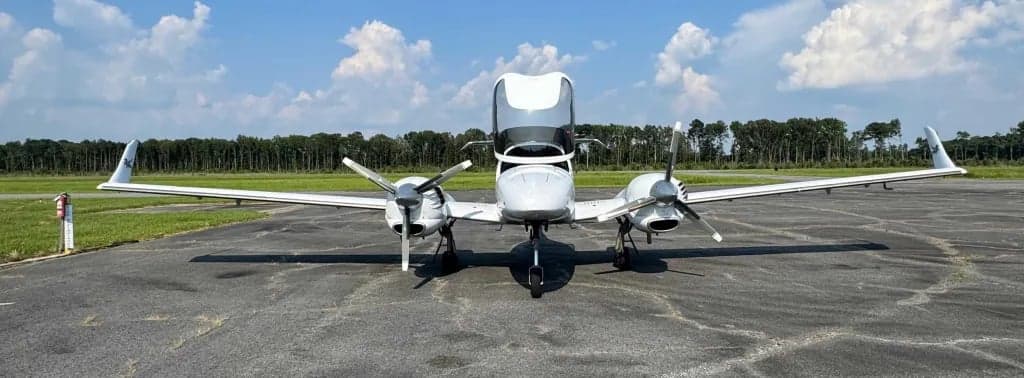Front view of a Diamond DA62 twin-engine aircraft on the tarmac.