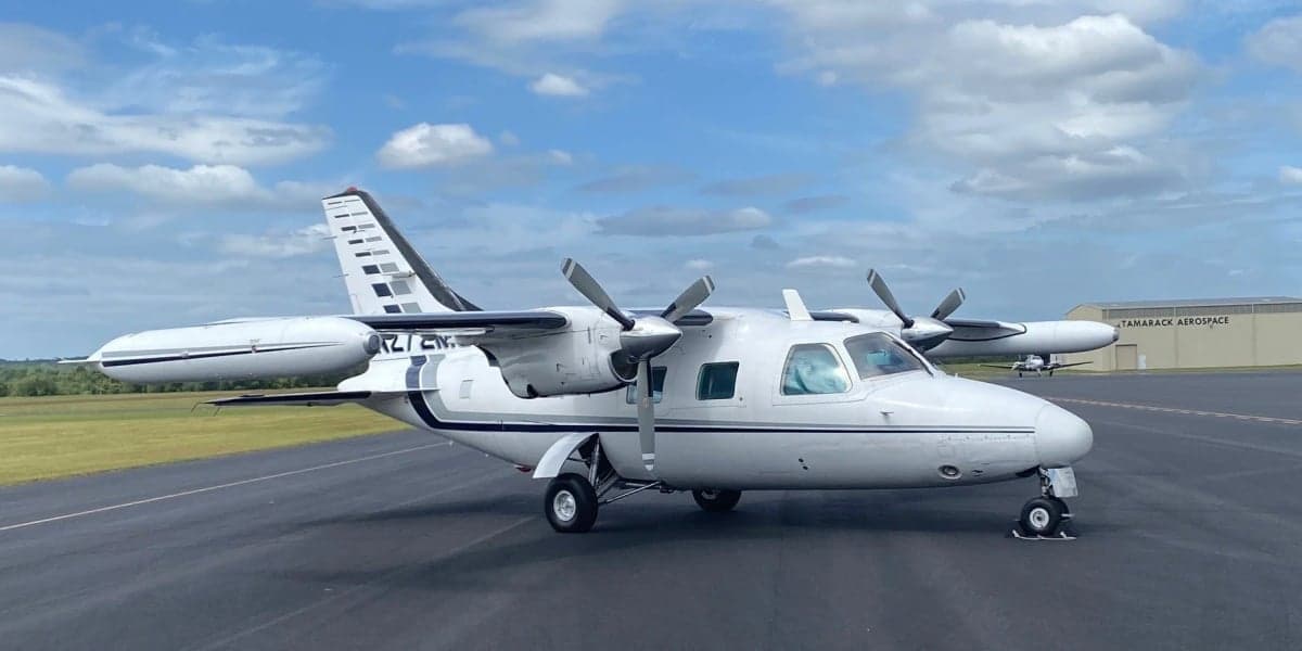 The aircraft N272MC is parked on the tarmac with a white and gray paint scheme.