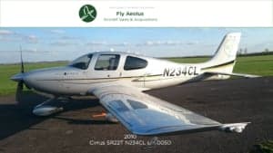 A Cirrus SR22T aircraft with registration N234CL parked on the tarmac.