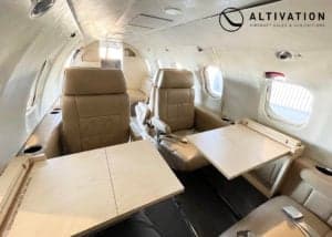 A Learjet in a hangar with the door open.