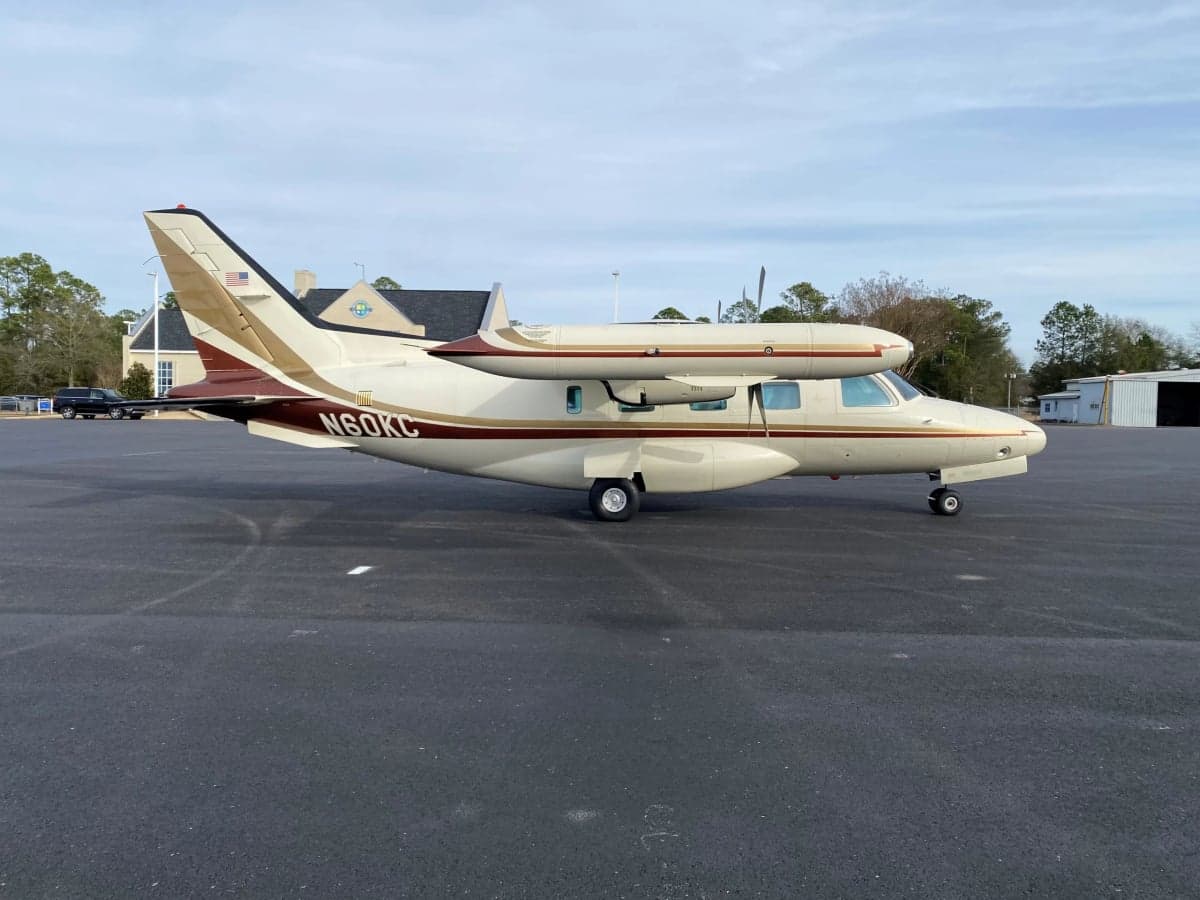 Side view of the Mitsubishi MU-300 Diamond aircraft with tail number N60KC on the tarmac.