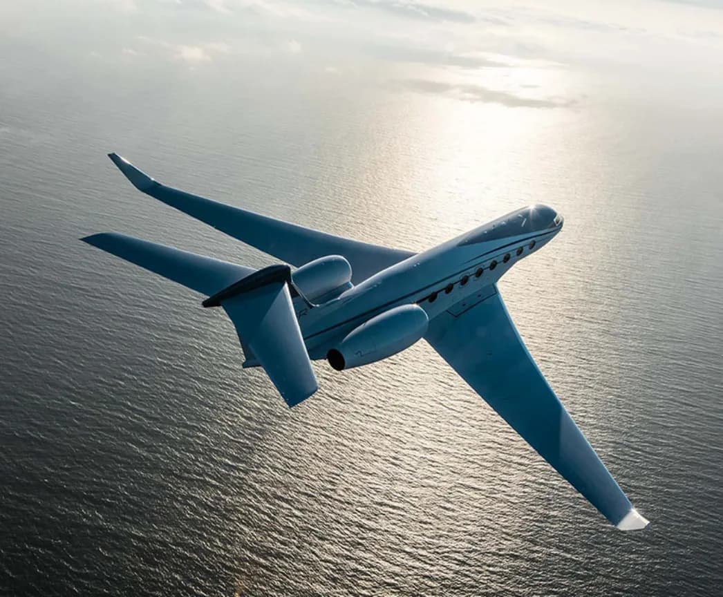 Gulfstream G650ER in flight over the ocean.
