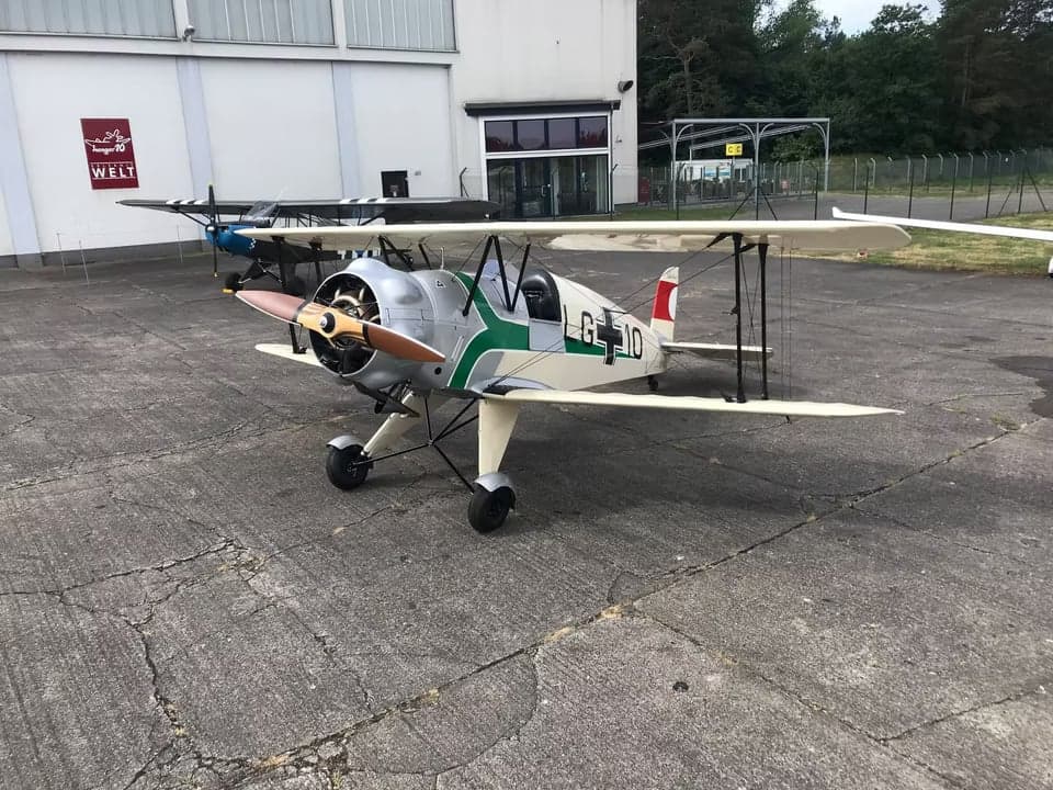 Rear view of the biplane aircraft on the tarmac.