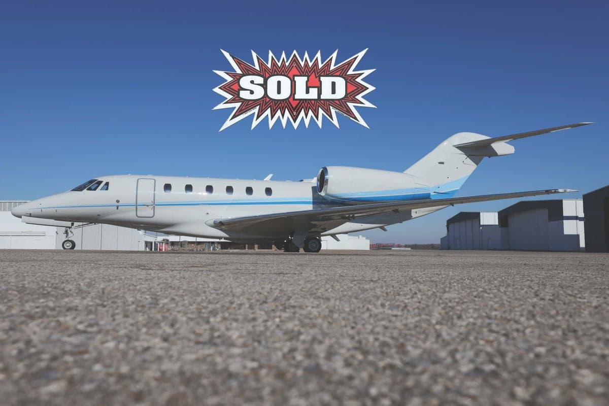 A Citation CJ3 aircraft with a blue and white paint scheme parked on the tarmac, with a SOLD graphic overlayed.