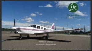 A 1981 Piper Saratoga aircraft with a white and red paint scheme on the tarmac.