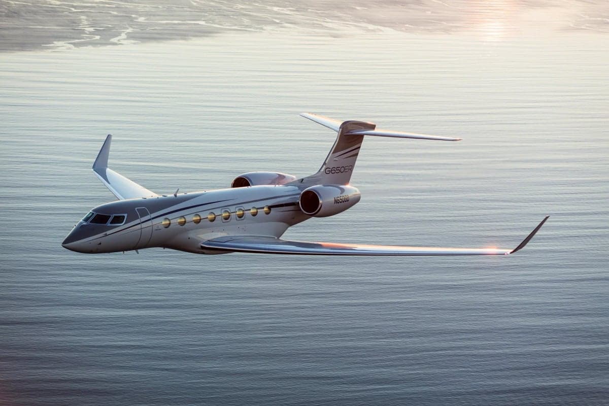 A Gulfstream G650ER flying over the ocean.