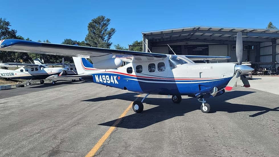 N4994K is a blue and white aircraft parked on the tarmac.