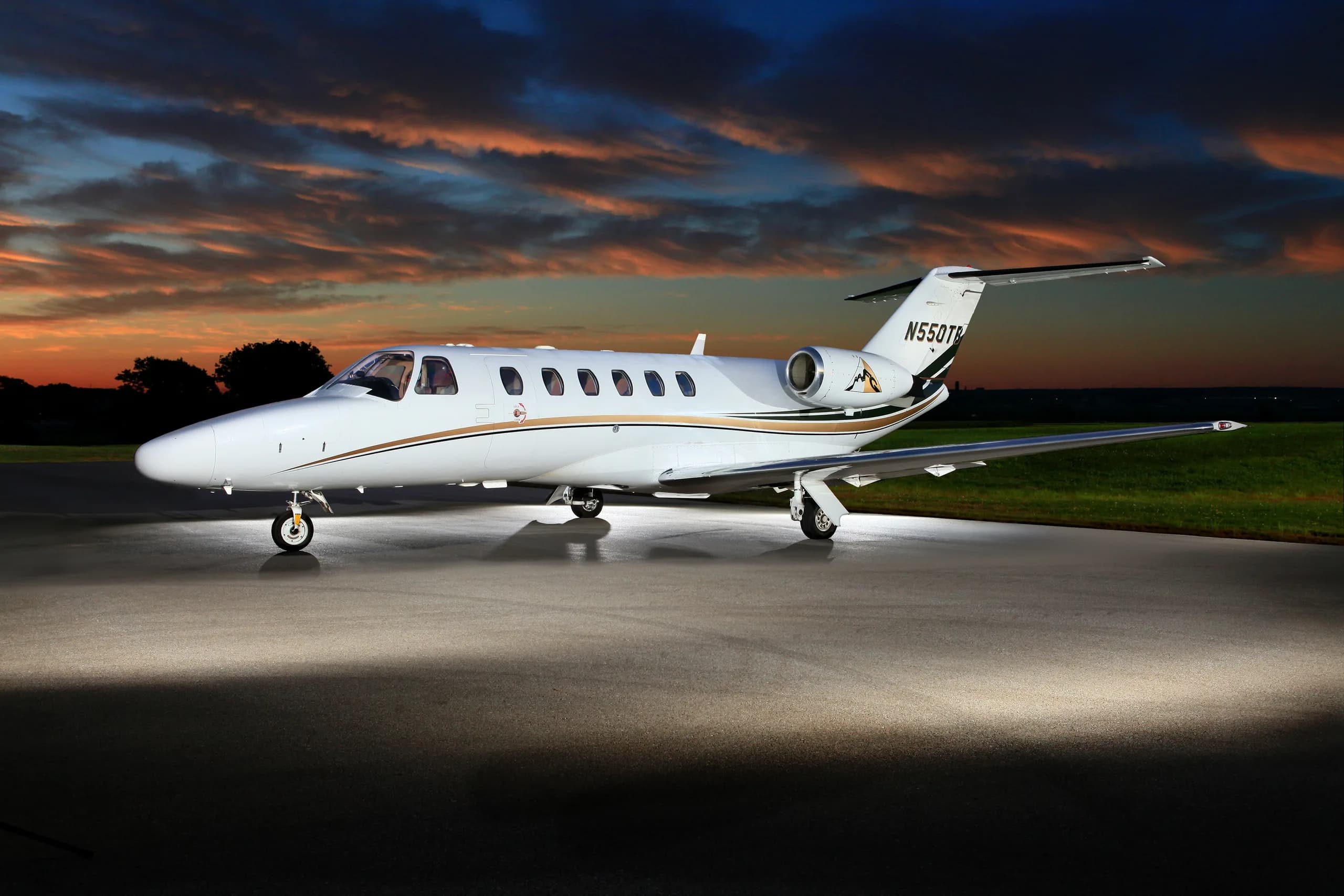 A Cessna Citation CJ1+ aircraft with registration N550TB parked on the tarmac at sunset.