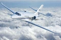 A white jet flying above the clouds.