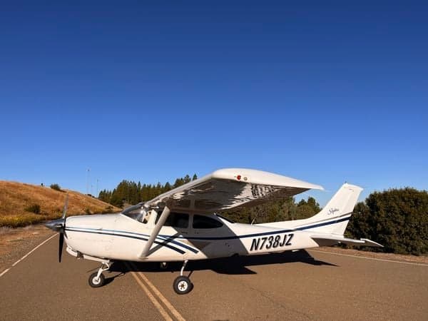 N738JZ, a Cessna Skylane, parked on a rural road.