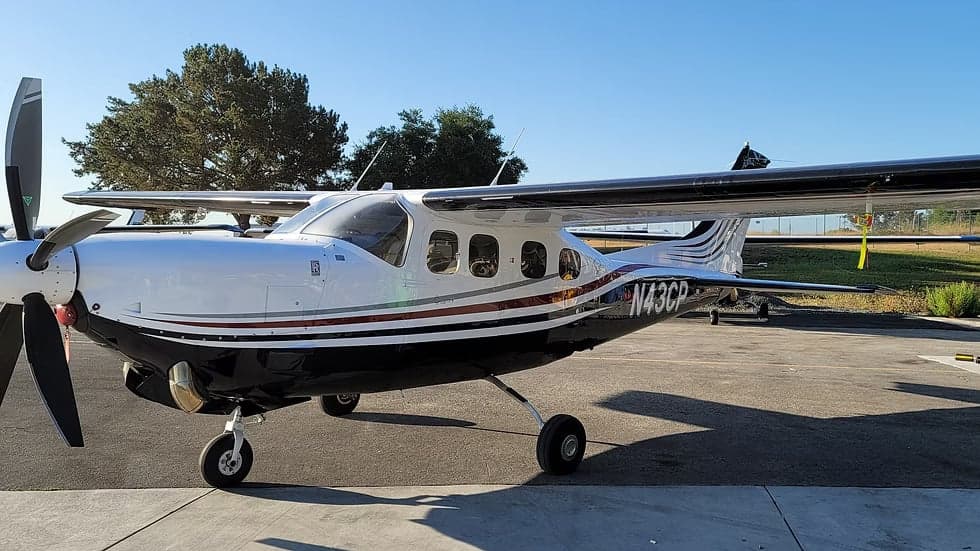 A side view of the N43CP aircraft on the tarmac.