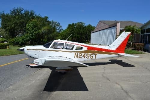 Piper PA-28-181 Archer II, registration N2495T, parked on the tarmac.